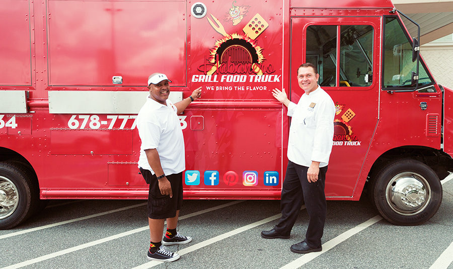 Culinary Apprenticeship graduate David Johnson shows Chef Robert Gerstenecker his new food truck during a visit to the College of Continuing and Professional Education.