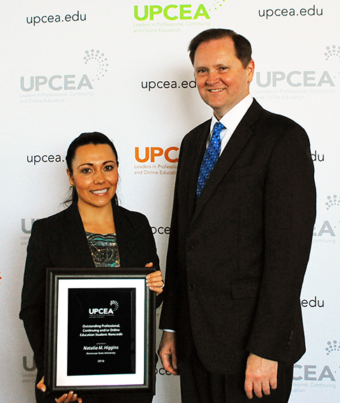 Natalia poses for a photo with UPCEA CEO Bob Hansen after the award ceremony April 8.