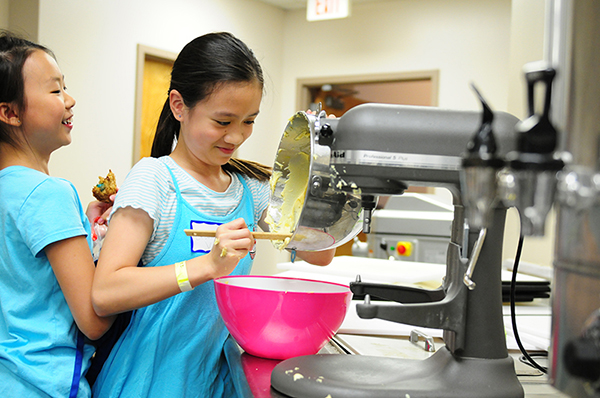 Kids cook in our catering kitchen during Summer U camps. 