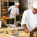 professional bakers in a kitchen baking bread